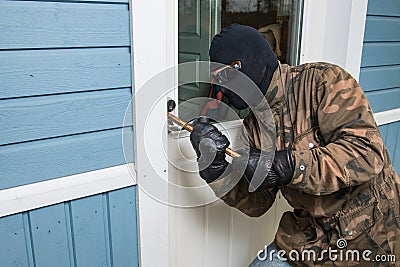 Fractional man breaking into a residential building in Finland. Stock Photo