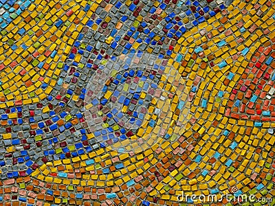 A fragment of an abstract mosaic ceramic panels on the wall. Multicolored stones. Stock Photo