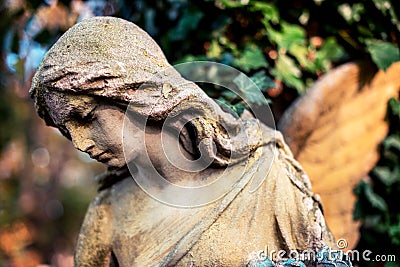 A fragment of ancient sculpture angel in the old cemetery. Symbol of love, invisible forces, purity, enlightenment, ministry, Stock Photo