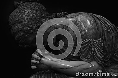 Fragment of an ancient statue of sad and desperate woman on tomb as a symbol of death, pain, sadness and sorrow Stock Photo