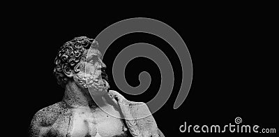 Fragment of an ancient stone statue of Hercules against black backgrouund as symbol of power and strength. Copy space Stock Photo