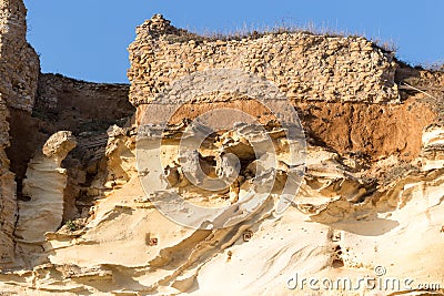 Fragment of ancient yellow stone wall and basement. The photo was taken in ruined Villa di Nerone, Anzio Stock Photo