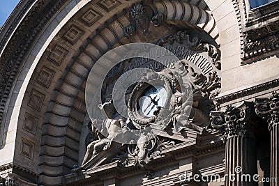 Fragment of architectural landmarks with a clock and ancient Greek gods on the old building of the National Bank of Romania Editorial Stock Photo