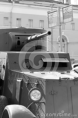 A fragment of an armored vehicle against background of a blurred bus stop sign Stock Photo