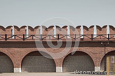 Fragment of bastion fort brick wall after restoration.Medieval border wall with curved prongs. Stock Photo