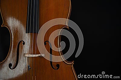 Fragment of a beautiful cello or violin on a black background Stock Photo