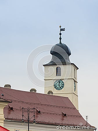 Fragment of the clock tower of the Roman Catholic Church of the Holy Trinity on the Large Square in Sibiu city in Romania Stock Photo