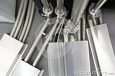 Fragment of a complex connection of many steel tubes and wires between various communication and control organs Stock Photo