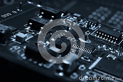 Fragment and components of a motherboard PCB of computer technology with many elements. Macro photography of processors and Stock Photo