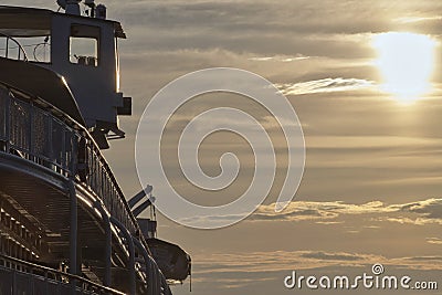 Fragment of a cruise ship in the rays of the setting sun, light toning Editorial Stock Photo