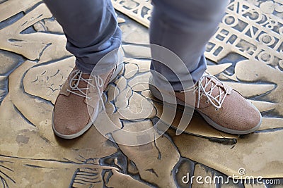 A person stands in light casual shoes Stock Photo