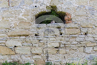 Fragment of defense stone wall of mediaeval castle with hole Stock Photo