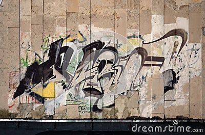 Fragment of an old wall with colorful graffiti painting Editorial Stock Photo