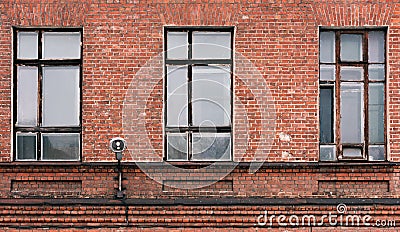 Fragment of the facade of an old brick building. High Windows and textural materials Stock Photo