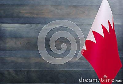 Fragment of the flag of the Kingdom of Bahrain in the foreground blurred light background copy space Stock Photo