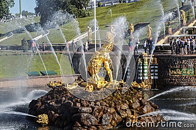 The fragment of the fountain `Grand Cascade` with a gilded sculpture of Samson tearing the lion`s mouth in the centre. Peterho Editorial Stock Photo