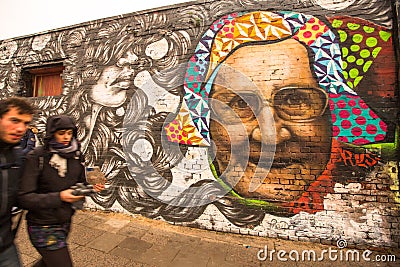 Fragment of graffiti on Berlin Wall at East Side Gallery - it's a 1.3 km long part of original Wall which collapsed in 1989 Editorial Stock Photo