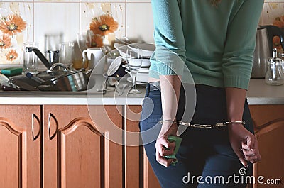 Fragment of the handcuffed female body at the kitchen counter, f Stock Photo