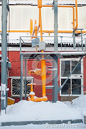 Fragment of an industrial gas pipeline with valves outdoors in winter Stock Photo