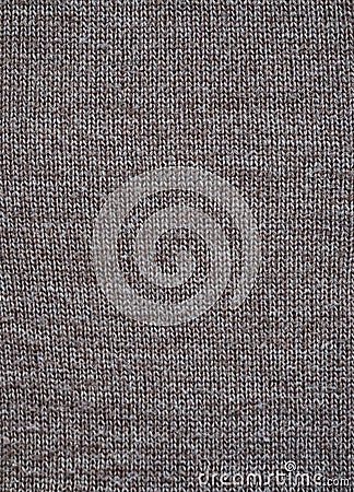 Fragment of a knitted fabric of handkerchief hand-knitted brown wool. View from above. Vertical Stock Photo