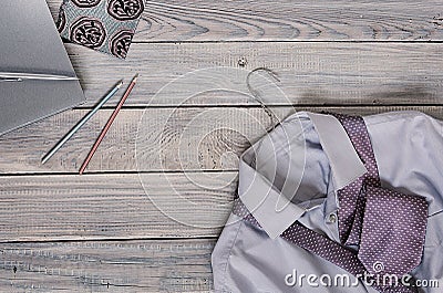 Fragment of a men`s shirt with a tie on a hanger and diary on a Stock Photo