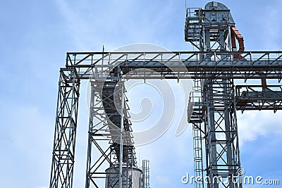 Fragment of metal grain elevator in facility with silos. Stock Photo