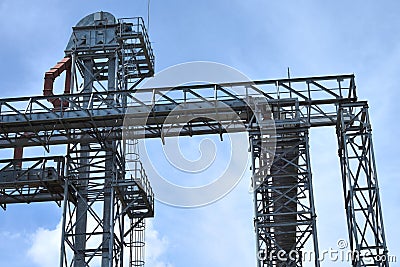 Fragment of metal grain elevator in facility with silos. Stock Photo