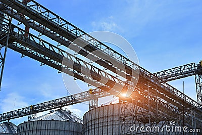 Fragment of metal grain elevator in facility with silos. Stock Photo