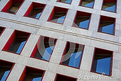 Fragment of modern building facade with red window frames Stock Photo