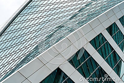 Fragment of a modern office building. Abstract geometric background. Part of a skyscraper with glass windows. Editorial Stock Photo