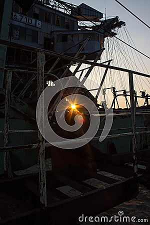 Fragment of a multi-bucket excavator giant against the light against the sunset Stock Photo