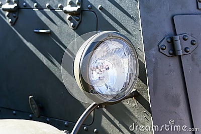 Fragment of an old armored vehicle, a khaki headlight Stock Photo