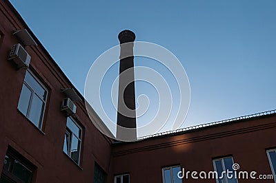 A fragment of an old brick factory building with a pipe Stock Photo