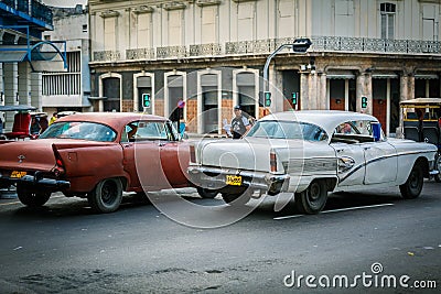 Fragment of old retro vintage classic old cars driving on authentic Cuban Havana city streets toward traffic lights Editorial Stock Photo