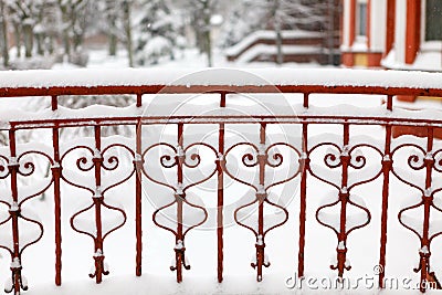 fragment of openwork fence covered with snow. Stock Photo