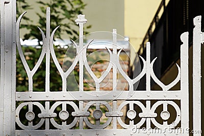 Fragment of openwork white forged fence close up Stock Photo