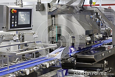 A fragment of the packaging system. Conveyor belt at a food factory Stock Photo