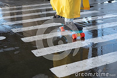 A fragment of a penny board at a pedestrian crossing. close-up Stock Photo