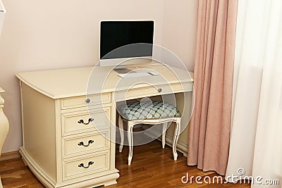 fragment of pink bedroom white wooden computer table with curtain, tulle closeup photo Stock Photo