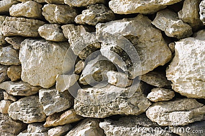 Fragment of a protective wall of yellow Maltese stone. Stock Photo