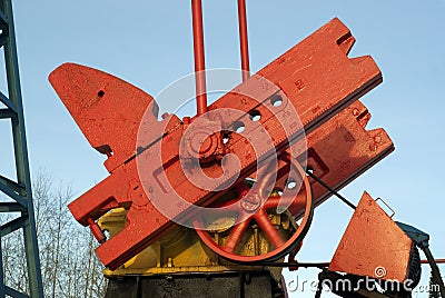 Fragment of pumpjack over an oil well Stock Photo