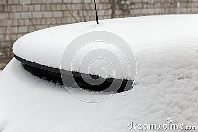 Fragment of the roof and back of parked snowbound car Stock Photo