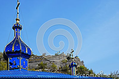 Fragment of roof with domes of Orthodox church overlooking chapel. Orthodox Monastery Stock Photo