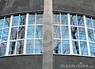 Fragment of roundish wall with big windows overlooking park Stock Photo