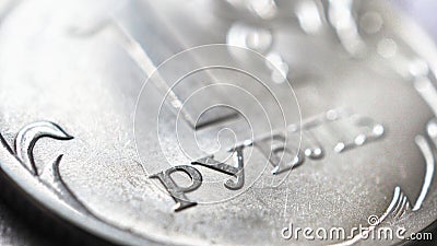 A fragment of a Russian coin in 1 one ruble close-up. Light background about the economy, finances and money of Russia. Textured Stock Photo