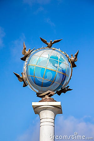 A fragment of the sculpture is a zero kilometer in Kiev on Independence Square. Earth globe and pigeons around it, a symbol of pe Stock Photo