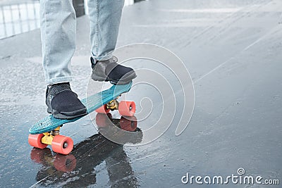 Fragment of a skateboard and legs close-up. Stock Photo