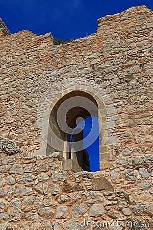 Fragment of a stone wall of an old castle with a gate. Landmark near Kritinia, Rhodes Stock Photo