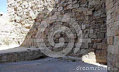 Fragment strongly weathered medieval castle wall on the island of Rhodes in Greece Stock Photo