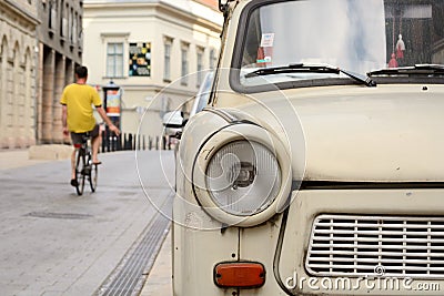 Fragment of Trabant car, bicyclist riding away Editorial Stock Photo